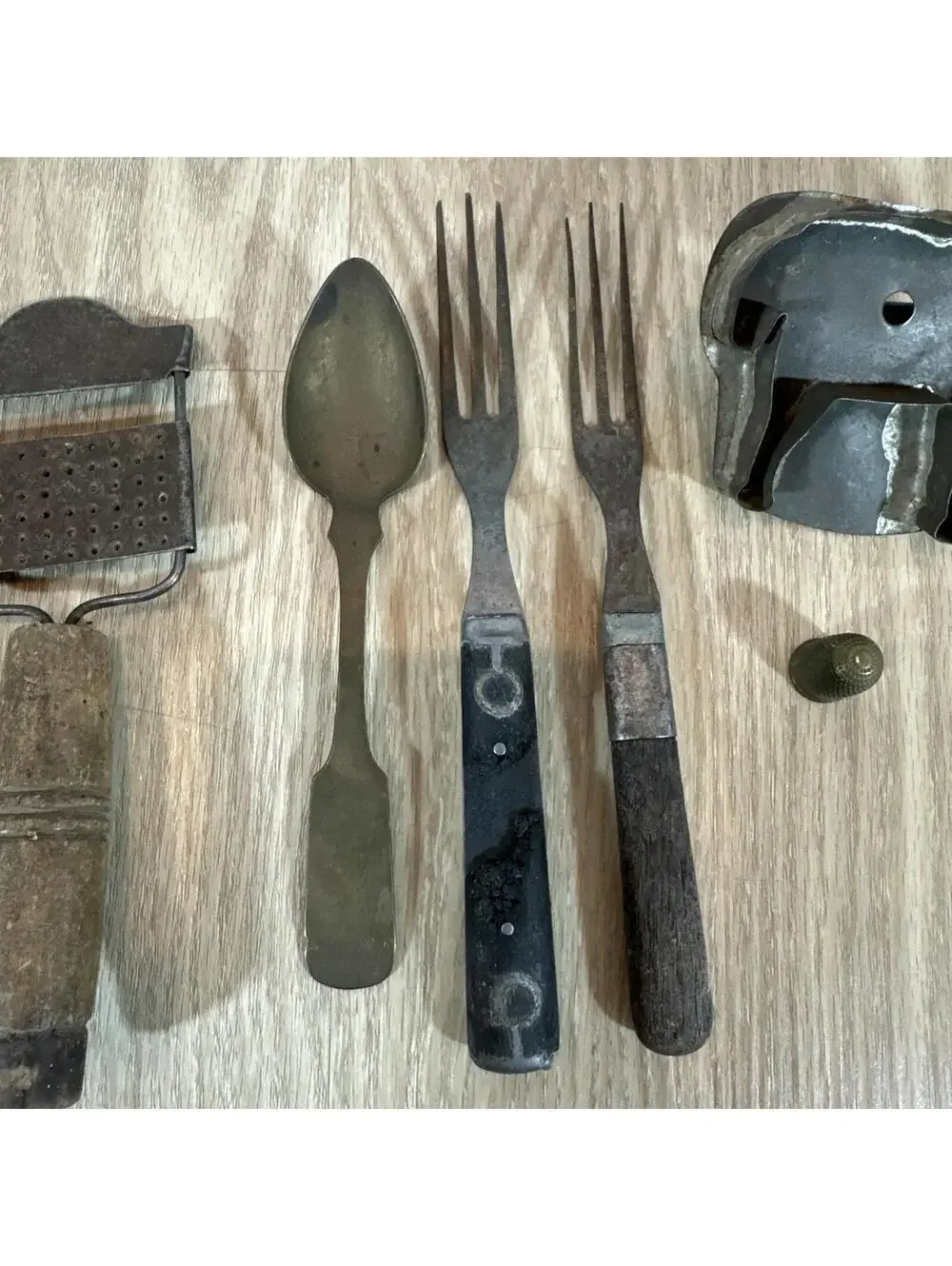 (7) Antique items: 2 graters, 2 forks, 1 spoon,‎ cookie cutter, thimble.